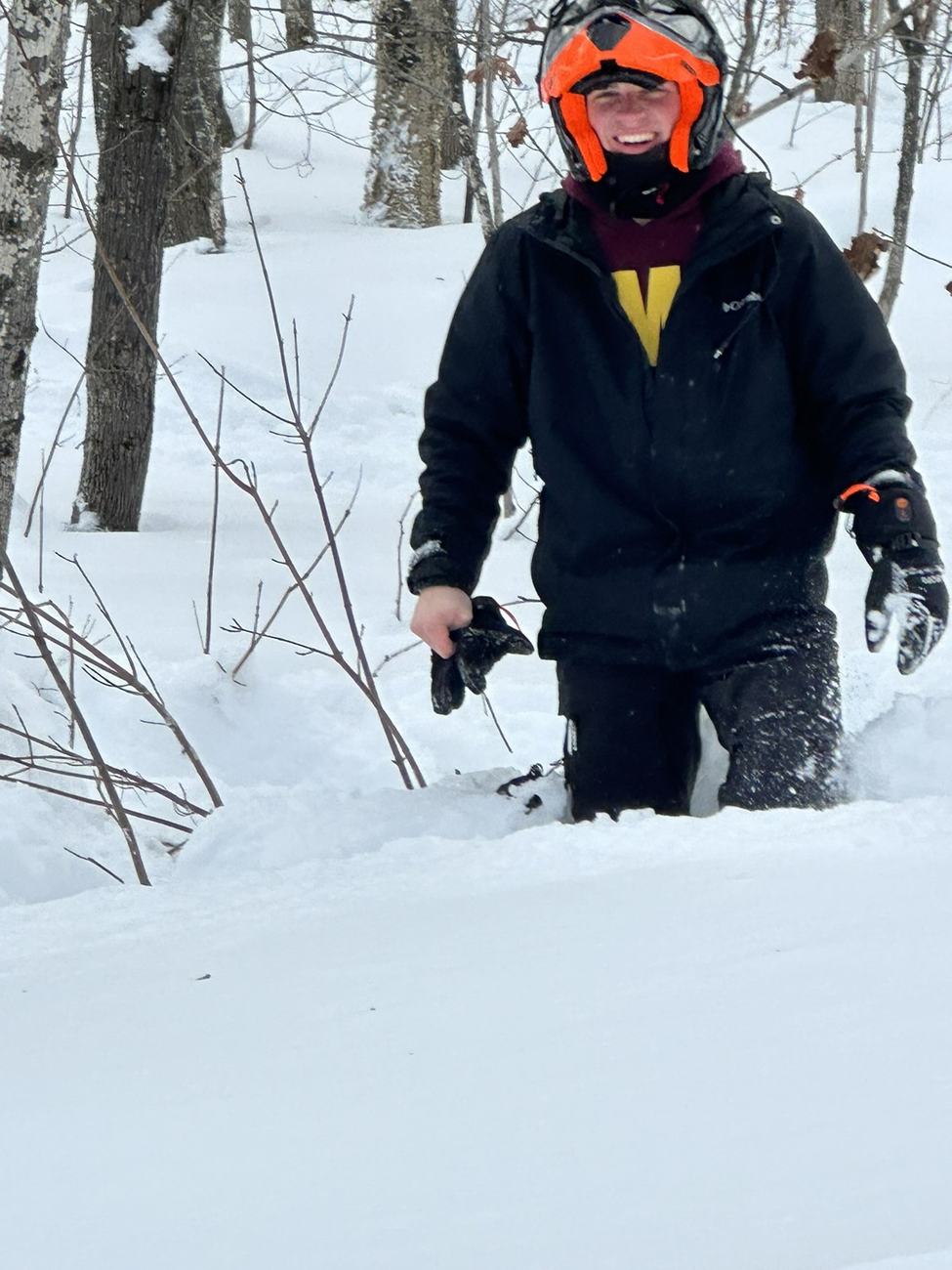 Snowmobiling through deep snow in the woods